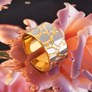 Macro view of bicolor two-tone pebble texture wide open ring with 18k gold plating