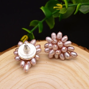 Elegant pink cluster pearl stud earrings on a wood slab featuring high-quality 925 silver studs