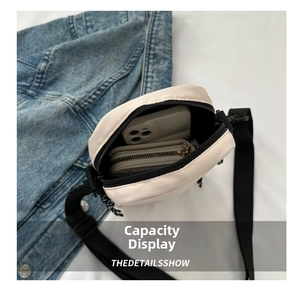 Internal view of beige oxford nylon crossbody bag showing smartphone and wallet storage
