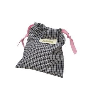 Checkered cotton drawstring pouch with pink cords for cosmetics and small accessories
