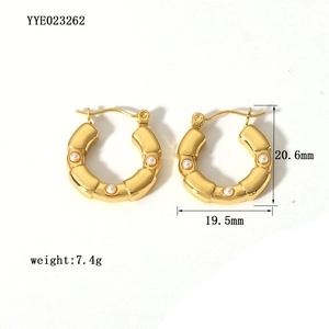 Detailed view of 18K gold plated hoop earrings featuring three inlaid white pearls