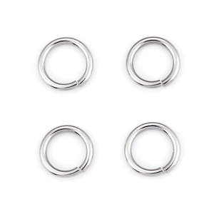 Detailed view of four polished silver stainless steel jump rings for DIY jewelry making