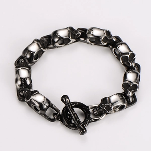 Detailed view of punk style skull link bracelet with vintage silver finish and OT clasp
