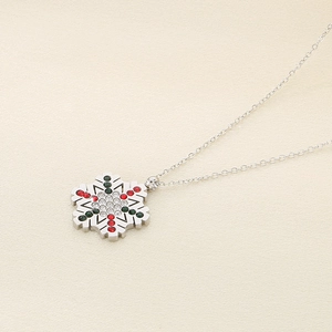 Detailed view of silver snowflake pendant necklace with red, green and white rhinestones