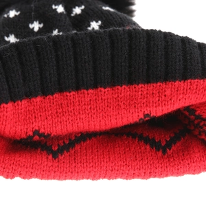 Macro detail of ribbed knit cuff and Christmas tree jacquard texture on winter hat
