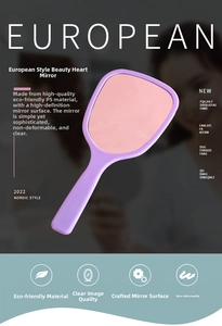 Close-up of heart-shaped handheld mirror with ergonomic handle in purple finish