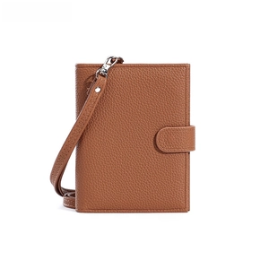 Brown litchi grain leather passport holder with adjustable long lanyard and silver buckle