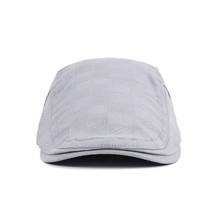 Detail view of light grey plaid newsboy cap showing textured fabric and curved brim