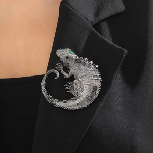 Vintage silver chameleon brooch with grey rhinestones on a black satin suit lapel