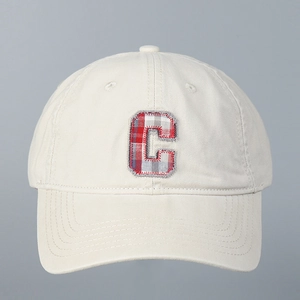 Close-up of checkered C-letter embroidery on a cotton baseball cap with fine stitching