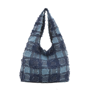 Blue denim patchwork hobo tote bag with distressed frayed edges and large capacity
