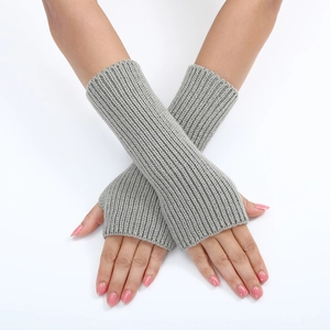 Close-up of grey striped knit fingerless gloves showing a stylish wrist sleeve texture