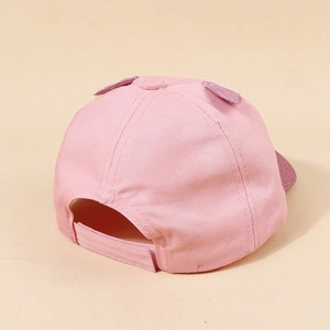 Detail of pink cotton baseball cap with sequin ears and adjustable velcro strap