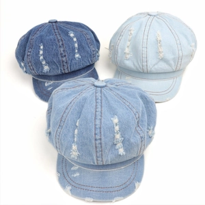 Distressed denim newsboy caps in three blue shades with ripped details for women