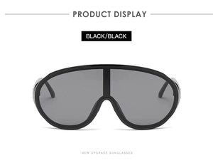 Detail view of large shield sunglasses in black with a modern oversized frame design