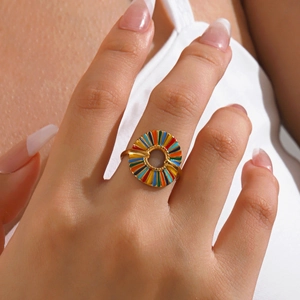 Golden stainless steel geometric ring with colorful enamel radial pattern on hand