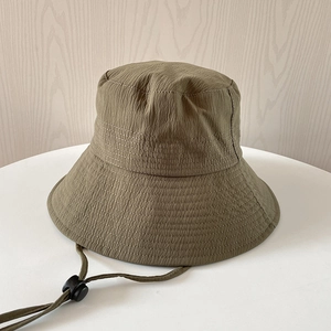 Detail of dark olive wide brim sun hat showing textured fabric and adjustable wind cord