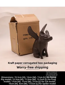 Detail of vintage cast iron flying pig figurine with cardboard packaging dimensions