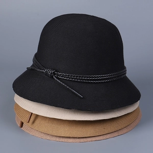 Close-up of lightweight knitted bucket hats stacked in beige, black, purple, and caramel