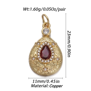 Detailed view of a gold teardrop pendant with red gemstone and technical dimensions