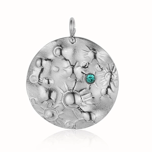 Detail of silver textured stainless steel moon pendant with turquoise stone inlay