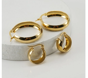 Detailed macro view of 18K gold plated thick hoop earrings in two sizes on stone