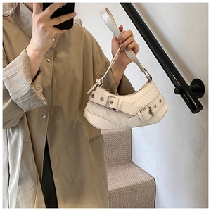 Mirror selfie showing a white leather motorcycle style shoulder bag with silver metal buckles