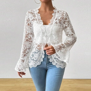 Detailed close-up of white floral lace fabric on elegant bell sleeves for women