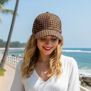 Classic autumn winter plaid baseball cap worn by model against a scenic beach background