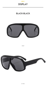 Front and 45-degree side view of oversized black square sunglasses with one-piece lens