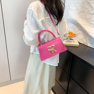 Chic rose red PU crossbody bag with golden R-letter buckle on model in white shirt