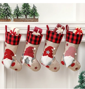 Close-up of four burlap gnome Christmas stockings hanging on a white fireplace mantel