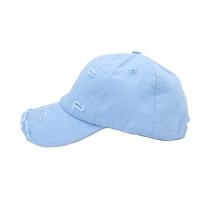 Detailed close-up of distressed brim and torn fabric on light blue cotton baseball cap