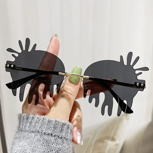 Retro rimless teardrop sunglasses with gray liquid lenses and gold metal temples