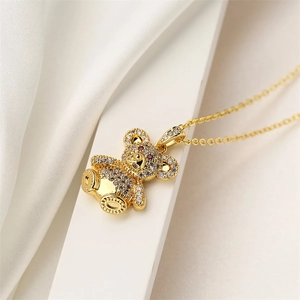 Macro detail of gold bear pendant necklace with micro-paved cubic zirconia stones