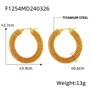 Close-up of gold-plated titanium steel hoop earrings with intricate woven mesh texture
