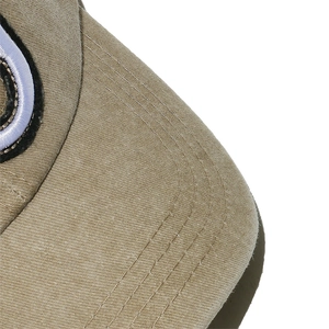 Close-up of the stitching details and premium cotton texture on a khaki baseball cap