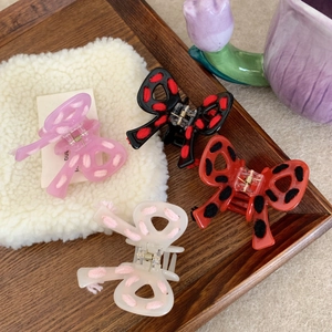 Colorful acetate butterfly hair claw clips with yarn knit details in various colors