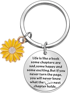 Macro detail of stainless steel sunflower keychain with engraved inspirational quote disk