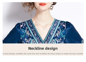 Detail view of the elegant V-neckline and intricate paisley pattern on a silky fabric