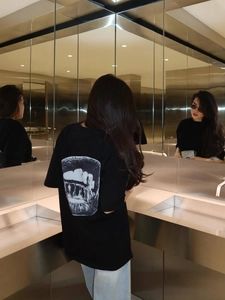 Black oversized graphic T-shirt with back print and dropped shoulders for a street style look