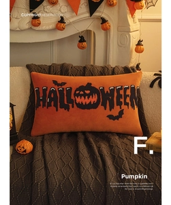 Detail of Halloween throw pillow with orange pumpkin embroidery on soft plush fabric