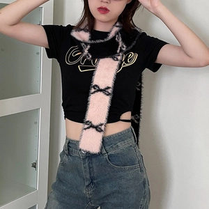Pink plush skinny scarf with black bow patterns shown on model in street style