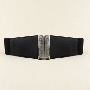 Detail of vintage silver alloy buckle with embossed floral patterns on black waist belt