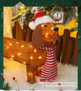 Close-up of lighted Dachshund dog Christmas figure with warm LED lights and scarf