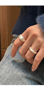 Detail of wide and narrow S925 sterling silver rings with a brushed matte finish