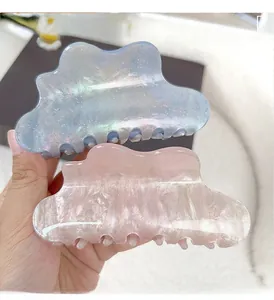 Detailed view of shimmering blue and marble pink cloud hair claws for elegant styling