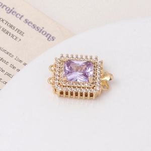 Macro detail of rectangle purple zircon jewelry clasp with micro-pave gold finish