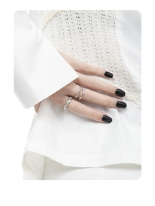 Close-up of S925 sterling silver rings with wavy design and crushed texture on hand