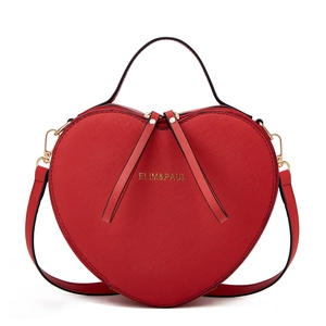 Detailed front view of a red heart-shaped bag with gold zippers and metal cross-texture